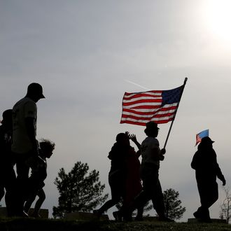 KILLEEN, TX - APRIL 04: People participate in a flag walk in memory of those killed and injured by Iraq war veteran, Ivan Lopez, on April 4, 2014 in Killeen, Texas. Lopez killed three and wounded 16 before taking his own life on the Fort Hood Army base. (Photo by Joe Raedle/Getty Images)