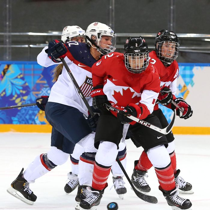 Meghan Agosta-Marciano #2 of Canada handles the puck against Lee Stecklein #2 of the United States in the second period during the Women's Ice Hockey Preliminary Round Group A game on day five of the Sochi 2014 Winter Olympics at Shayba Arena on February 12, 2014 in Sochi, Russia.