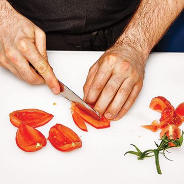 3. Slice tomato quarters lengthwise.