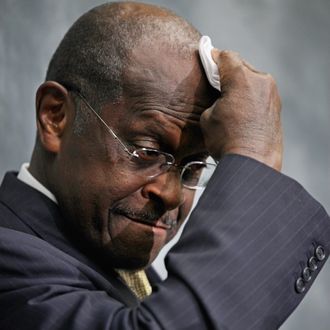 Republican presidential candidate and former CEO of Godfather's Pizza Herman Cain wipes his brow while participating in a discussion with members of the Congressional Health Care Caucus on Capitol Hill November 2, 2011 in Washington, DC. Part of the 