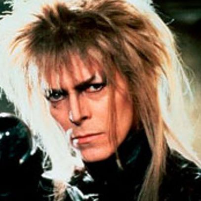 Blond Factor: 2. Dirty, with visible roots
Evil Factor: 2. Kidnaps a child, attempts to seduce another child, hangs with goblins, performs a cheesy Magic Dance.
Conclusions: Noticeable dark streaks or dye jobs of any kind really dilute evil and mark a villain as a poser. He doesn't actually hurt anybody, which is a tip that he's nothing but a pixie with a mischievious streak; that's about as evil as a rock star in a kid's movie can get.