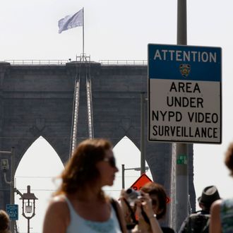 A white flag flies atop the west tower of New York's Brooklyn Bridge, Tuesday, July 22, 2014. Two large American flags atop the Brooklyn Bridge were replaced sometime during the night with white banners. Police crime scene and intelligence detectives were investigating how the flags were switched out on the famed span that connects Brooklyn and Manhattan, and there were no reports of suspicious activity, police said. (AP Photo/Richard Drew)