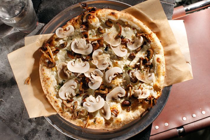 The mushroom pizza is made with fresh and roasted 'shrooms, smoked mozzarella, and ricotta.