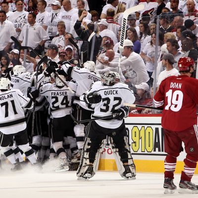 Dustin Penner #25 of the Los Angeles Kings celebrates with teammates Slava Voynov #26, Jeff Carter #77 and Mike Richards #10 after Penner scores the game-winning goal in overtime as the Kings defeat the Phoenix Coyotes 4-3 in Game Five of the Western Conference Final during the 2012 NHL Stanley Cup Playoffs at Jobing.com Arena on May 22, 2012 in Phoenix, Arizona. 