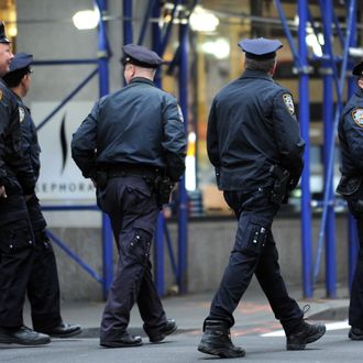 New York Police Department officers walk along a street in Lower Manhattan March 18, 2012 in New York.
