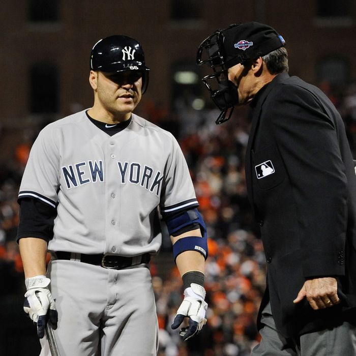 Russell Martin #55 of the New York Yankees argues with home plate umpire Angel Hernandez after striking out in the eighth inning of Game Two of the American League Division Series against the Baltimore Orioles at Oriole Park at Camden Yards on October 8, 2012 in Baltimore, Maryland.