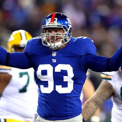 Middle linebacker Chase Blackburn #93 of the New York Giants reacts after sacking quarterback Aaron Rodgers #12 of the Green Bay Packers in the second quarter at MetLife Stadium on November 25, 2012 in East Rutherford, New Jersey.