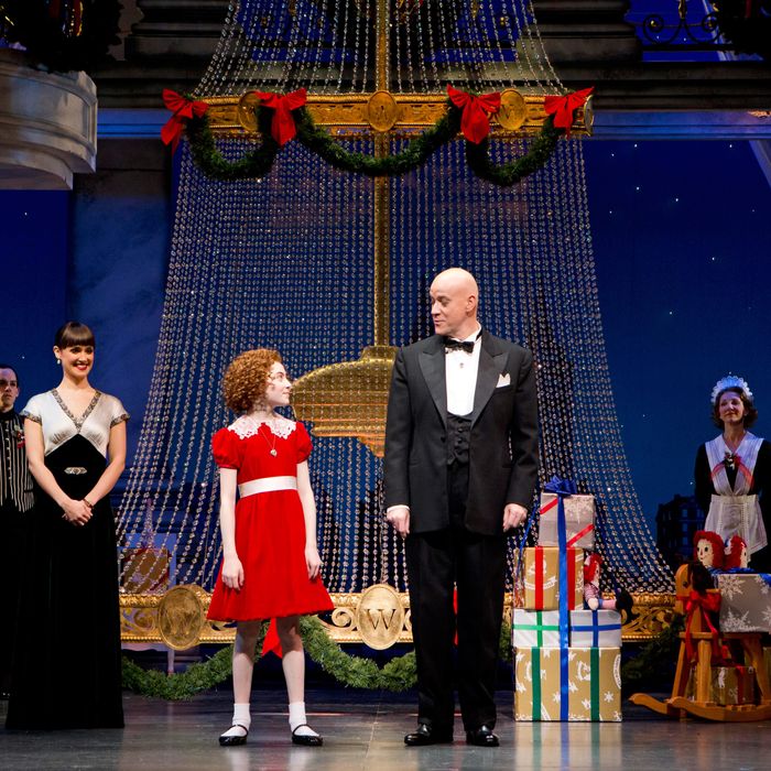 (l-r) Brynn O’Malley (Grace Farrell), Lilla Crawford (Annie), Anthony Warlow (Oliver Warbucks) and Ensemble in ANNIE at the Palace Theatre (Broadway at 47th Street). ANNIE features a book by Thomas Meehan, music by Charles Strouse and lyrics by Martin Charnin. The production is choreographed by Andy Blankenbuehler and directed by James Lapine.