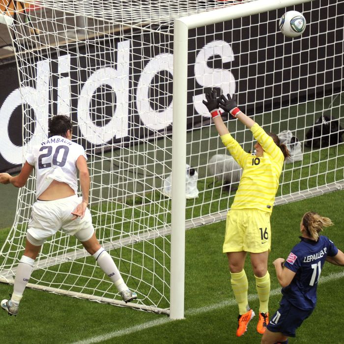 USA's striker Abby Wambach (L) heads the ball past France's goalkeeper Berangere Sapowicz to hit the crossbar during the FIFA women's football World Cup semi final match France vs USA in Moenchengladbach, western Germany, on July 12, 2011. AFP PHOTO / ODD ANDERSEN (Photo credit should read ODD ANDERSEN/AFP/Getty Images)