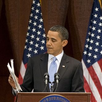 US President Barack Obama holds up letters he has received from citizens who need health care as he speaks with members of the House Democratic Caucus at the US Capitol in Washington, DC, March 20, 2010. Obama looked to energize his Democratic allies Saturday with an in-person appeal for his historic health care overhaul on the eve of a cliffhanger vote on the sweeping legislation. AFP PHOTO/Jim WATSON (Photo credit should read JIM WATSON/AFP/Getty Images)