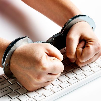 Handcuffed fists hit computer keyboard in frustration