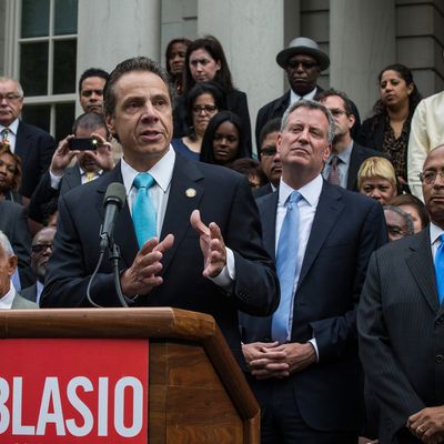 NEW YORK, NY - SEPTEMBER 16: New York Governor Andrew Cuomo, (L) speaks outside New York City Hall after New York City mayoral hopeful Bill Thompson (R) conceded defeat to New York City Democratic mayoral candidate Bill De Blasio (C), on September 16, 2013 in New York City. Thompson and De Blasio both hoped to win the democratic cadidate position for New York City. While De Blasio had a majority lead in the primary vote with approximately 40% of the votes, Thompson had hoped that he could force a run off between the two. (Photo by Andrew Burton/Getty Images)