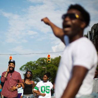 Protesters link arms while marching toward City Hall to demonstrate the police-custody death of Freddie Gray, Thursday, April 30, 2015, in Baltimore. Baltimore police say they have turned over their criminal investigation to a prosecutor who will decide whether charges are warranted in the death of Freddie Gray. (AP Photo/David Goldman)