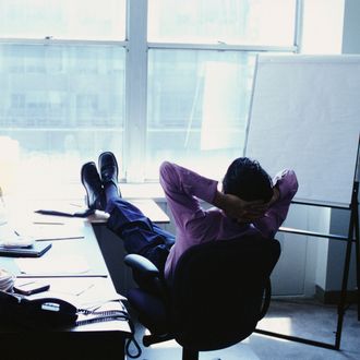 Businessman with Feet Up in Office