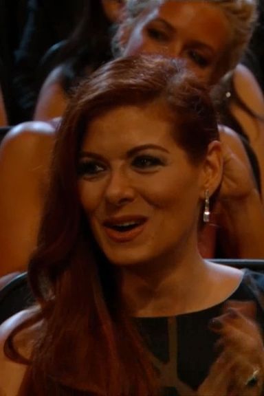 Debra Messing is saying "joke," which she famously says in lieu of actually laughing.