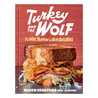 The cover of the Turkey and the Wolf cookbook, red with a sandwich on it
