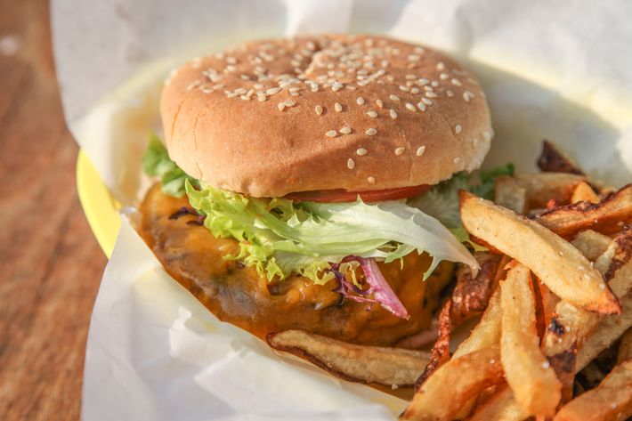 Grass-fed beef burger with secret sauce and cheddar on a sesame bun.