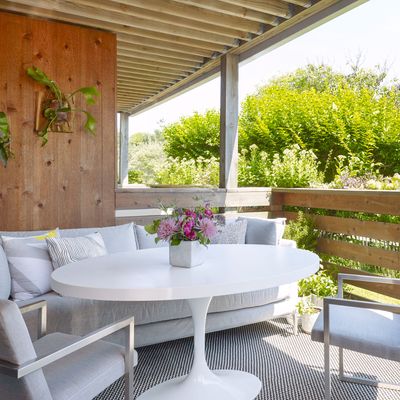 This covered porch is the apartment’s main gathering place. Photo: Peter Murdock