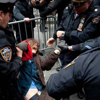 Members of the New York City Police Department (NYPD) arrest a demonstrator in New York, U.S., on Thursday, Nov. 17, 2011. New York police stood prepared for tens of thousands of Occupy Wall Street demonstrators to descend on the Financial District, and ringed the area with metal barricades to deter crowds from reaching their goal of surrounding the New York Stock Exchange. Photographer: Scott Eells/Bloomberg via Getty Images