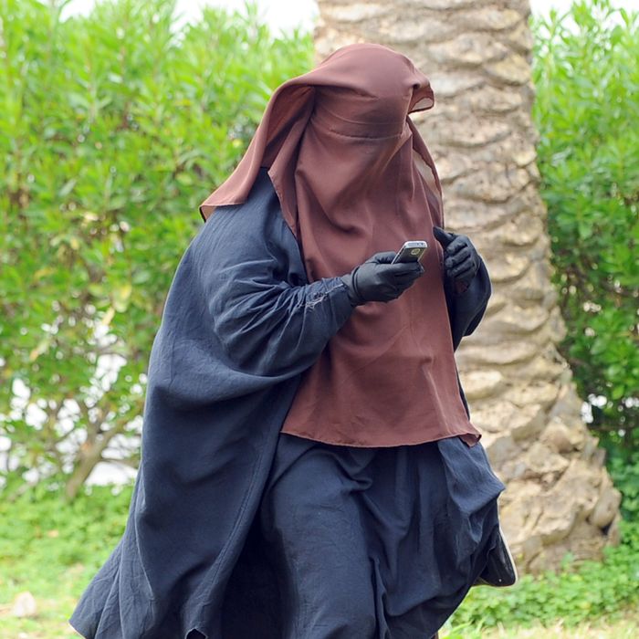 A Tunisian student wearing a niqab speeks on the phone at the Manuba university on March 7, 2012 in Tunis. Four students wearing the niqab head veil started a hunger strike on January 17, after the end of a similar hunger strike at the university which ended on January 5. Habib Kazdaghli, the Dean of the Faculty of Letters, Arts and Humanities at the University of Manuba, told an AFP journalist he would call for the dispersal of the group of Salafist students who have gathered and been involved in activities to disrupt classes and exams, their actions having caused a delay in examinations. AFP PHOTO / FETHI BELAID (Photo credit should read FETHI BELAID/AFP/Getty Images)