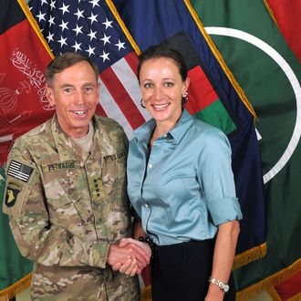 UNSPECIFIED - JULY 13, 2011: In this handout image provided by the International Security Assistance Force (ISAF), former Commander of International Security Assistance Force and U.S. Forces-Afghanistan; CIA Director Gen. Davis Petraeus (L) shakes hands with biographer Paula Broadwell, co-author of 