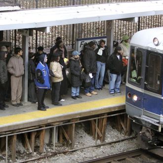 Passengers wait as the Metro-North passenger train approaches the platform 21 December, 2005 at the Fordham Rd station in the Bronx borough of New York. Metro-North offered passengers in the Bronx, who normally use subways and buses, an alternative way to get into Manhattan during the transit strike. The city's nearly 34,000 subway and bus workers stayed out for a second day on Wednesday despite a court order fining their union one million dollars per day during the stoppage.