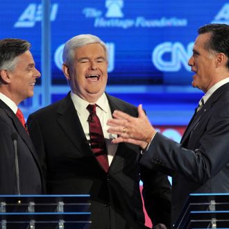 Former House speaker Newt Gingrich (C) and former Massachusetts governor Mitt Romney (R) prior to the start of the Republican presidential debate on national security November 22, 2011.