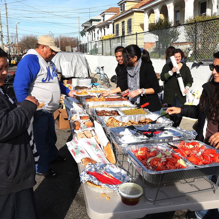 Volunteers from Astoria distribute food to needy and displaced residents on Beach 24th Street on November 20, 2012 in Far Rockaway, Queens, New York. More than three weeks after Superstorm Sandy hit the New York area, residents continue their restoration efforts in many affected areas in the New York region.