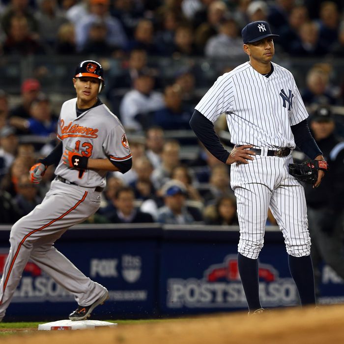 Alex Rodriguez #13 of the New York Yankees looks on as Manny Machado #13 of the Baltimore Orioles advances to third base on a double by Nate McLouth during Game Four of the American League Division Series at Yankee Stadium on October 11, 2012 in the Bronx borough of New York City.