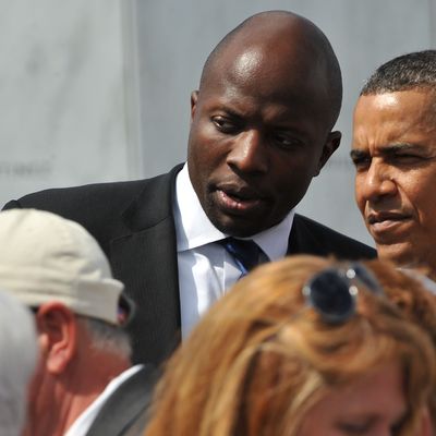 US President Barack Obama listens to his personal assistant Reggie Love as he greets family members of victims aboard United flight 93 on September 11, 2011 after he laid a wreath at the Wall of Names at the newly dedicated Flight 93 memorial on the site where the plane crashed in a field in Shanksville, Pennsylvania. AFP PHOTO/Nicholas KAMM (Photo credit should read NICHOLAS KAMM/AFP/Getty Images)