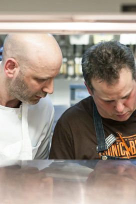 Chef Marc Vetri looks on as Paul Kahan plates.
