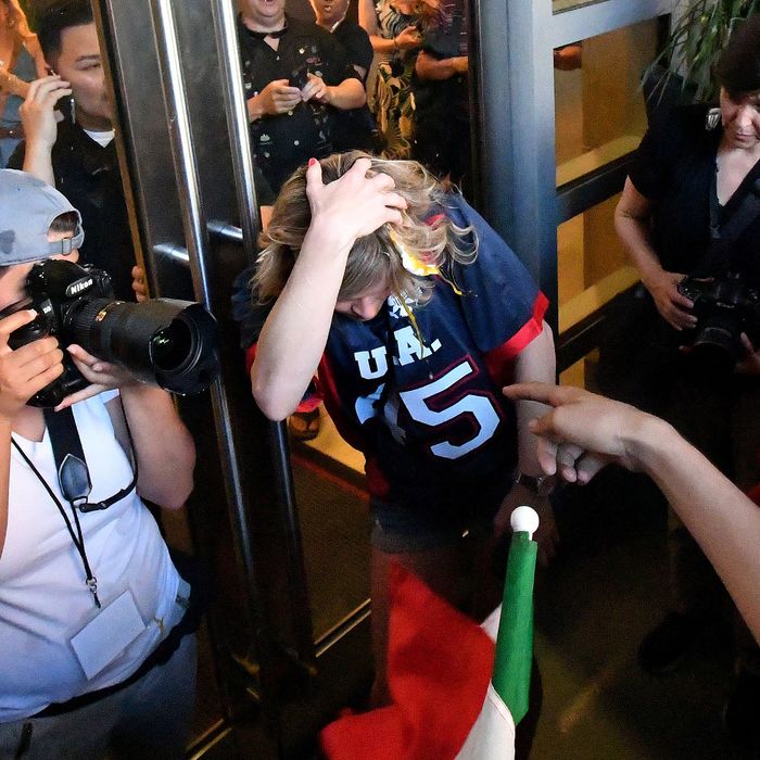 A woman wearing a Trump shirt is pelted with eggs by protesters while pinned against a door near where Republican presidential candidate Donald Trump holds a rally in San Jose, California on June 02, 2016. 