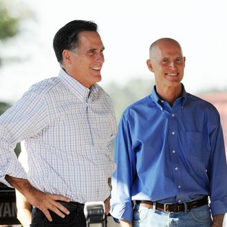 Former Massachusetts Governor Mitt Romney (L) and Rick Scott, Republican gubernatorial candidate for Florida, smile during a rally on October 1, 2010 in The Villages, Florida.