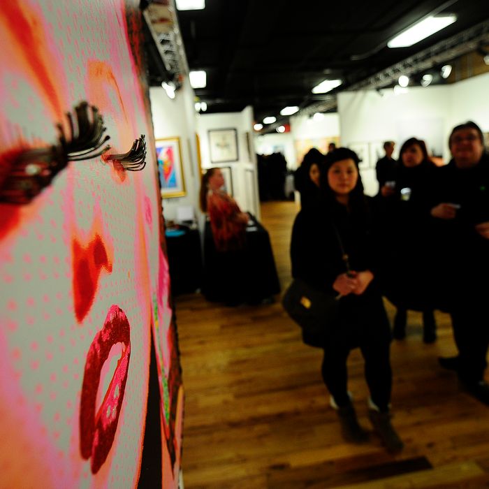 Visitors walks through the Red Dot Art Fair and the Korean Art Show, in New York, March 3, 2011. New York kicked off its annual art week with shows and art fairs throughout the city such as The Armory Show, Fountain , Red Dot, Volta NY, and Pulse amongst others , are expected to draw more than 60,000 attendees and generate more than $40 million in economic activity in New York City. AFP PHOTO/Emmanuel Dunand (Photo credit should read EMMANUEL DUNAND/AFP/Getty Images)