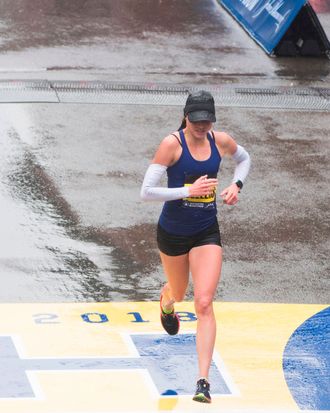 Sarah Sellers crossing the finish line at the Boston Marathon.