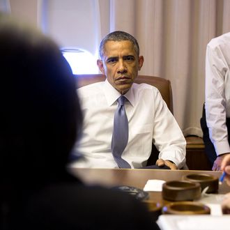 President Barack Obama holds a meeting with National Security Advisor Susan E. Rice, John Podesta, Counselor to the President and Phil Reiner, Senior Director for South Asian Affairs, aboard Air Force One en route to New Delhi, India, Jan. 25, 2015. (Official White House Photo by Pete Souza)This official White House photograph is being made available only for publication by news organizations and/or for personal use printing by the subject(s) of the photograph. The photograph may not be manipulated in any way and may not be used in commercial or political materials, advertisements, emails, products, promotions that in any way suggests approval or endorsement of the President, the First Family, or the White House.