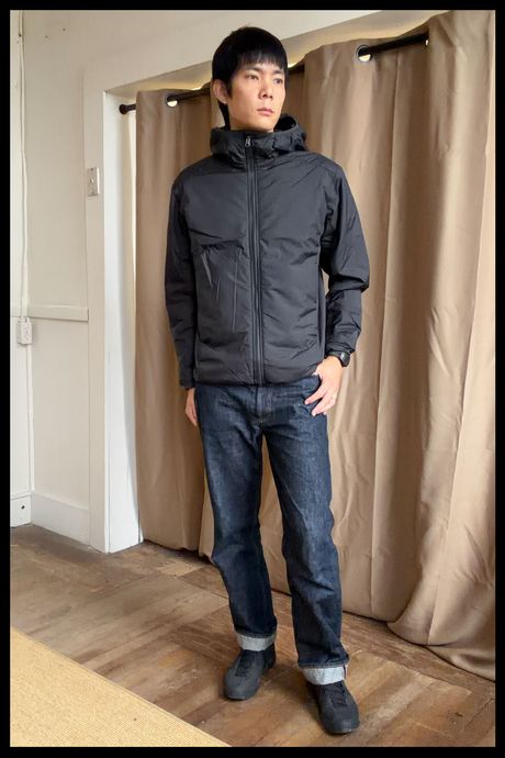 Photo of Strategist senior writer Michael Zhao wearing the Quince Men's Hybrid Insulated Lightweight Jacket. 
