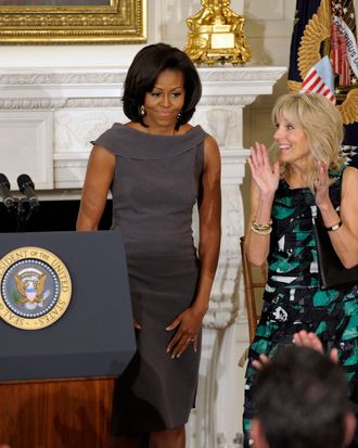 First lady Michelle Obama is applauded by Dr. Jill Biden after speaking before the National Governors Association, Monday, Feb. 27, 2012, in the State Dining Room of the White House in Washington.