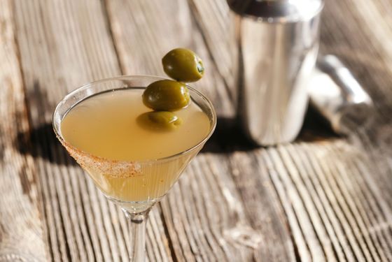 Mexican Martini: Pueblo Viejo blanco tequila, fresh lime, Combier orange liqueur, olive juice, Fire and Damnation Habanero bitters, Serrano olives, sweet hot salt (chili powder, paprika, salt, sugar)