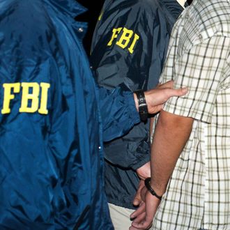 FBI agents escort suspect