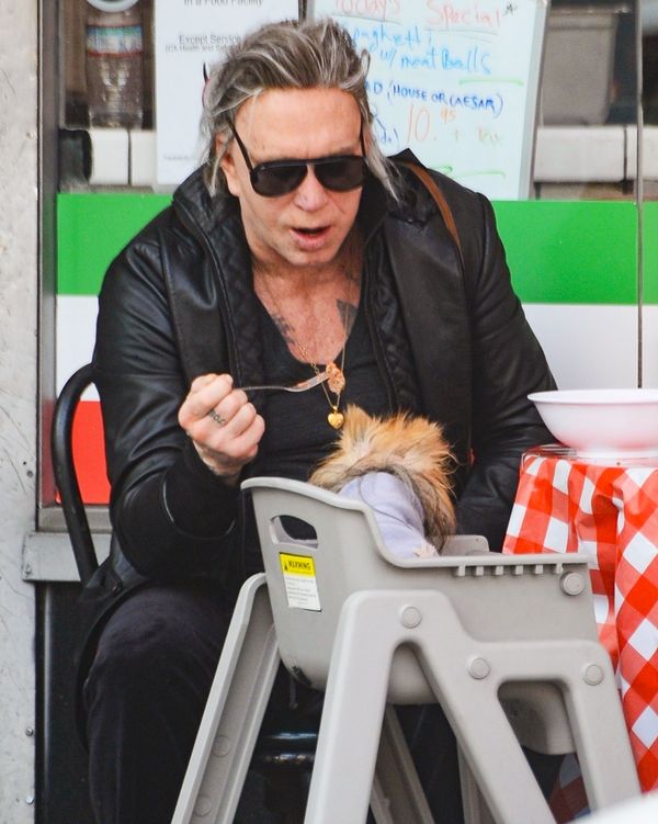 Mickey Rourke feeding his Pomeranian, Number One.