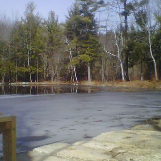 Ice partially covers the surface of Jew Pond in Mont Vernon, N.H., Monday, March 12, 2012.