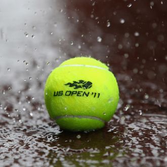 NEW YORK, NY - AUGUST 27: Heavy rain falls on a tennis ball as Hurricane Irene heads up the east coast during previews at USTA Billie Jean King National Tennis Center on August 27, 2011 in New York City. (Photo by Julian Finney/Getty Images)