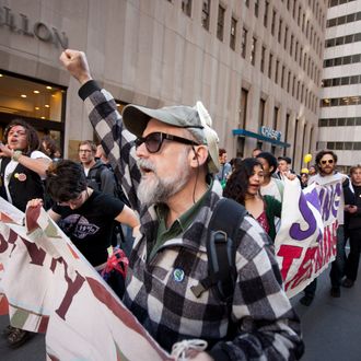 Demonstrators associated with the 'Occupy Wall Street' movement march up Broadway near Wall Street.