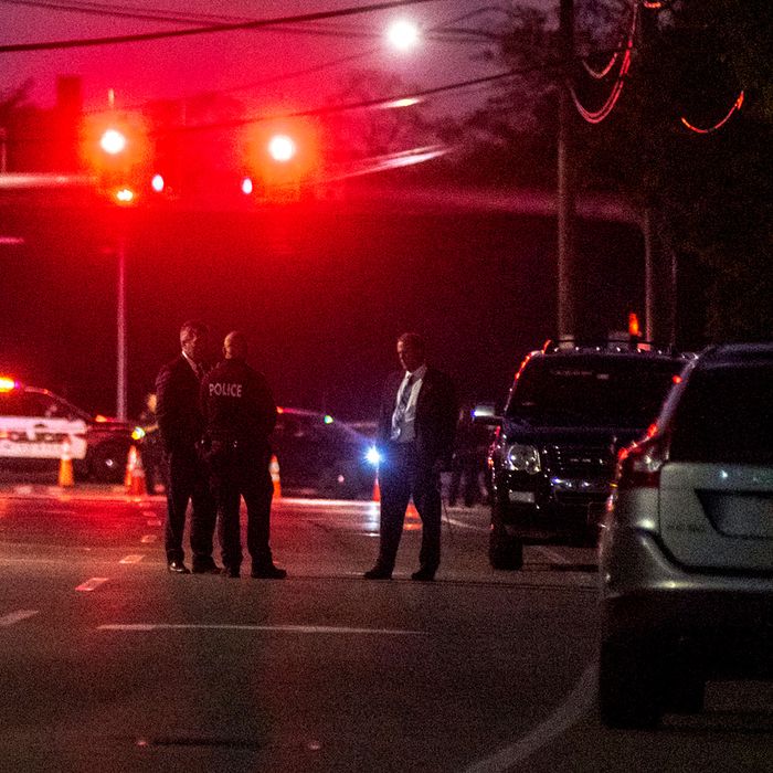 Police officers in Amityville, N.Y., the scene of the fatal stabbing.