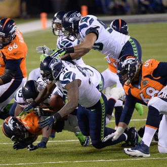 EAST RUTHERFORD, NJ - FEBRUARY 2: Denver Broncos running back Knowshon Moreno (27) fumbles the ball during the first quarter. The ball was received by Denver Broncos guard Zane Beadles (68). The Denver Broncos vs the Seattle Seahawks in Super Bowl XLVIII at MetLife Stadium in East Rutherford, New Jersey Sunday, February 2, 2014. (Photo by AAron Ontiveroz/The Denver Post)