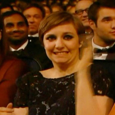 Lena Dunham realizes that she has mistakenly wandered in front of a television camera with her clothes on.