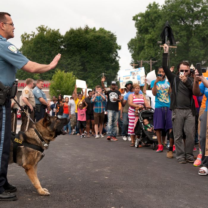 Protestors confront police during an impromptu rally, Sunday, Aug. 10, 2014 to protest the shooting of Michael Brown, 18, by police in Ferguson, Mo. Saturday, Aug. 9, 2014. Brown died following a confrontation with police, according to St. Louis County Police Chief Jon Belmar, who spoke at a news conference Sunday. (AP Photo/Sid Hastings)