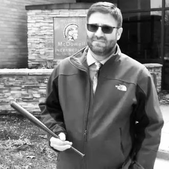 Millcreek Education Association president Jon Cacchione with a tiny bat.