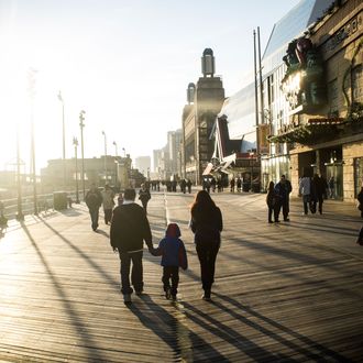 Tourists and residents walk along the crowded boardwalk on December 1, 2012 in Atlantic City, NJ. 